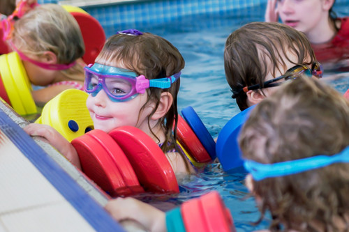 Children taking part in swimming lesson