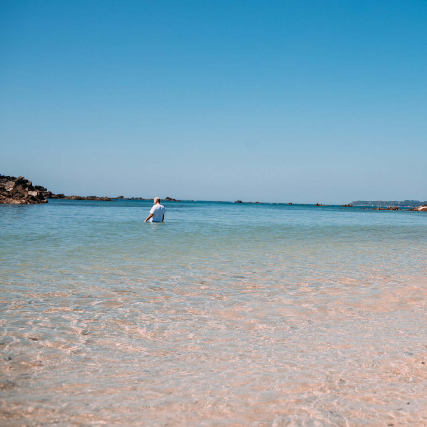 Couple walking along the beach at Green Island