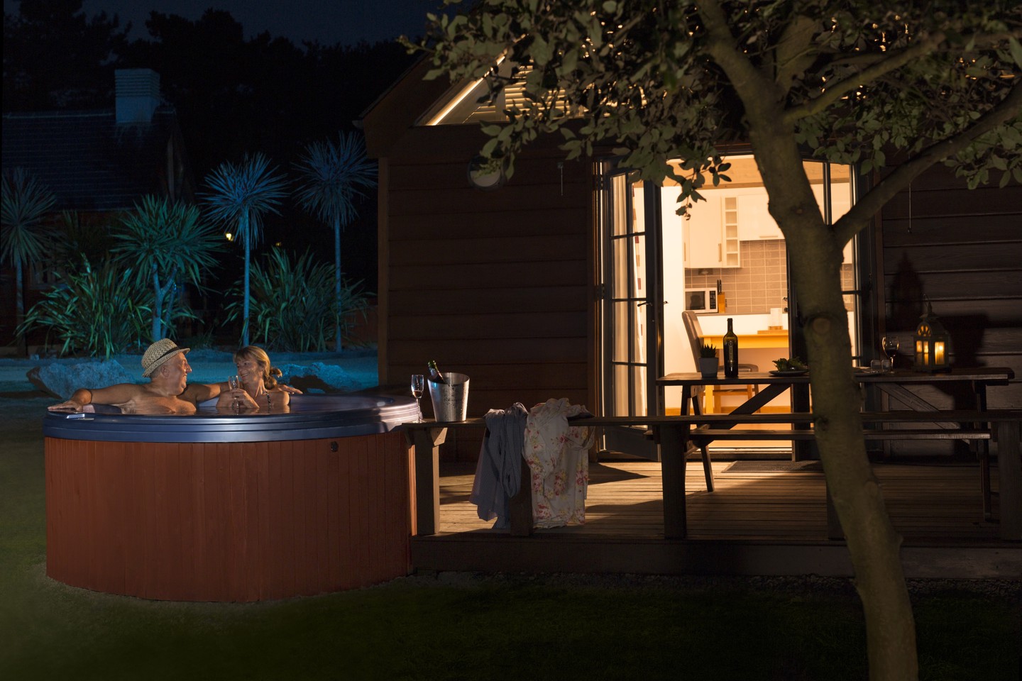 Couple in hot tub outside at night