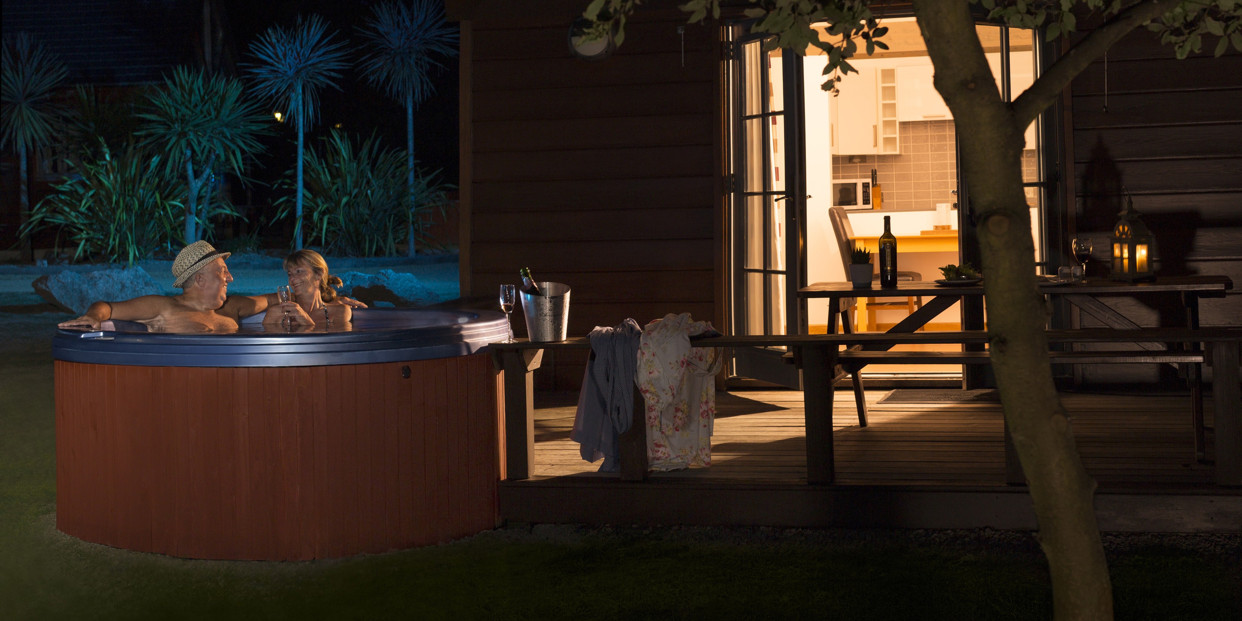 Couple in hot tub outside at night