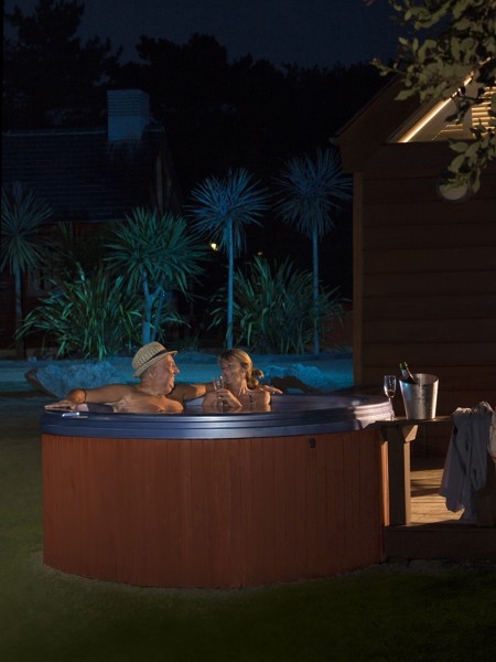 Couple in hot tub outside at night