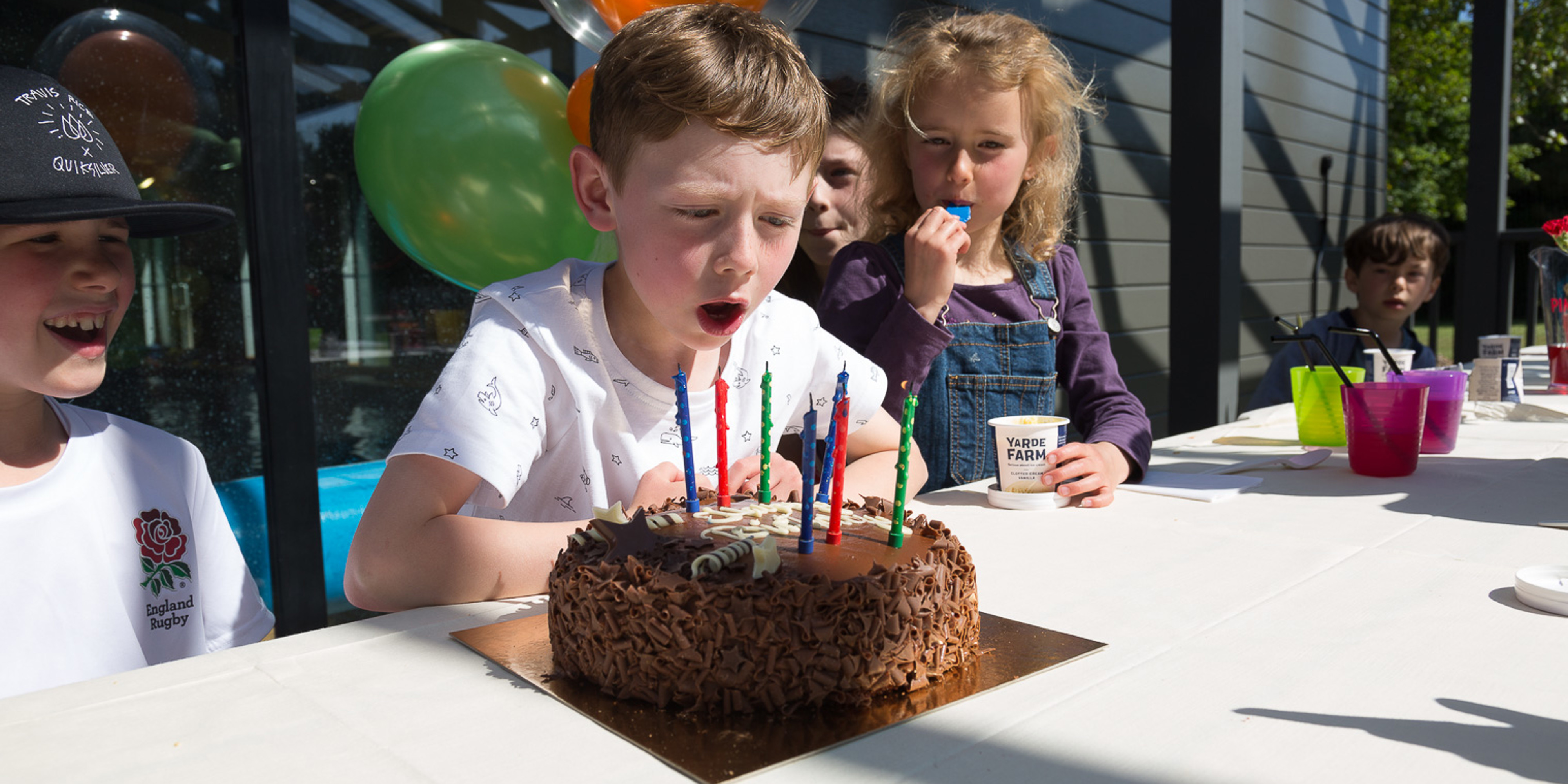 Boy blowing out birthday cake candles