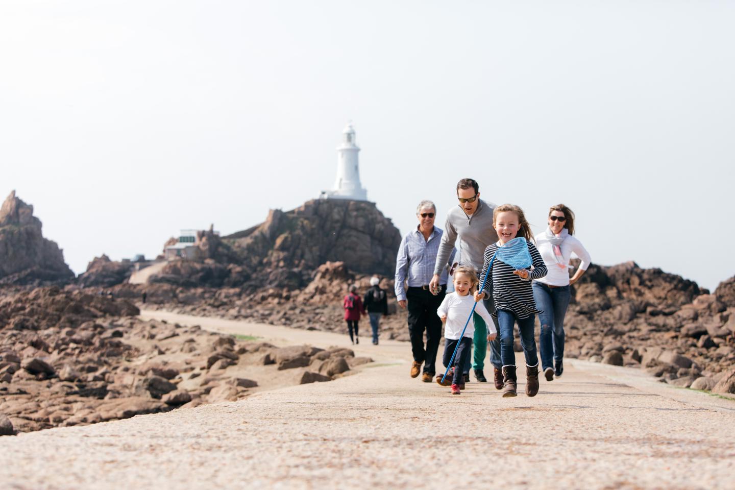 Family smiling down at Corbiere Lighthouse