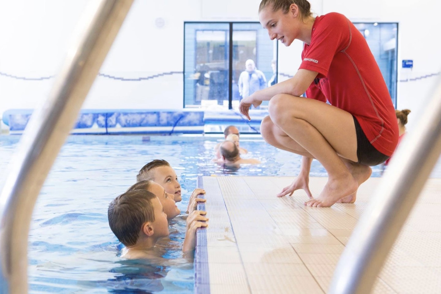 Swim instructor teaching children