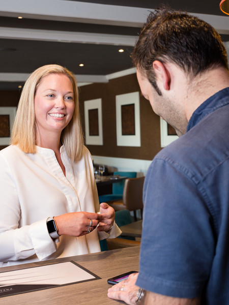 Staff greeting customer