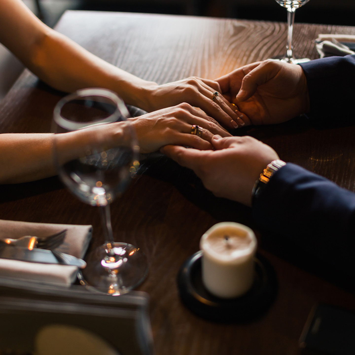 Couple holding hands at table